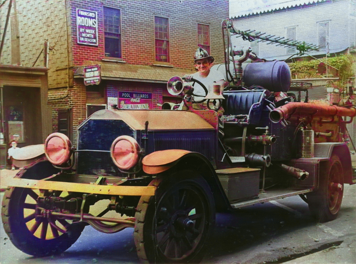 FDNY Lieutenant Christopher J. Baione on a vintage fire apparatus